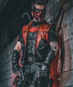 Front view showing black and red asymmetrical leather vest